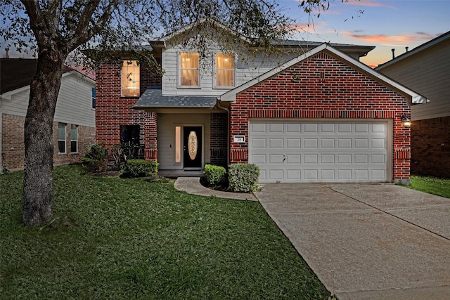 traditional-style home with a front lawn, driveway, a shingled roof, an attached garage, and brick siding