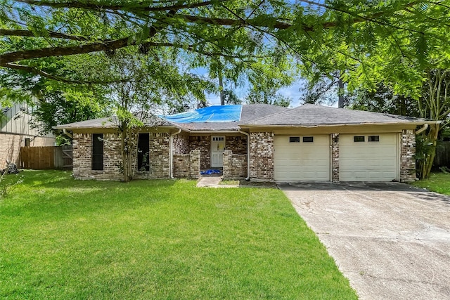 ranch-style home featuring an attached garage, fence, a front yard, and concrete driveway