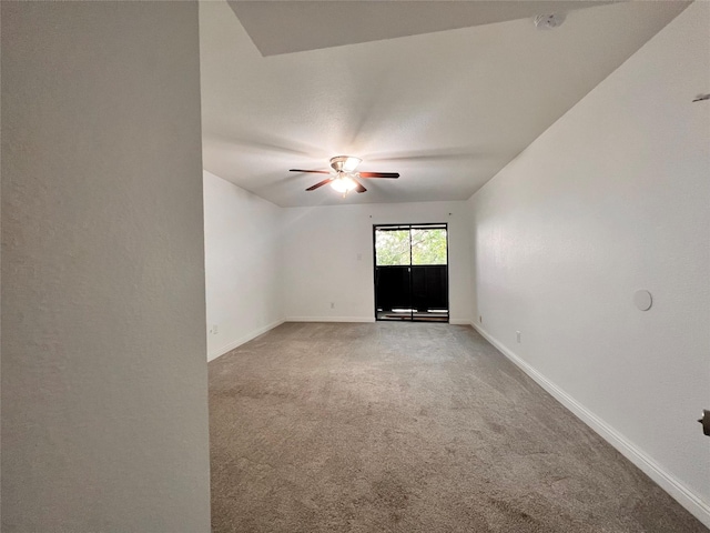 spare room featuring baseboards, a ceiling fan, and light colored carpet