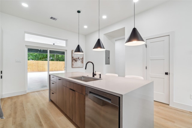 kitchen featuring stainless steel dishwasher, a sink, visible vents, light wood-style floors, and modern cabinets