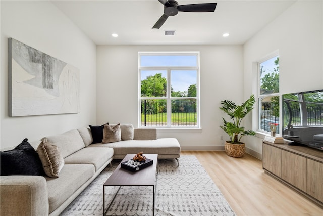 living room featuring baseboards, visible vents, recessed lighting, light wood-style floors, and a ceiling fan