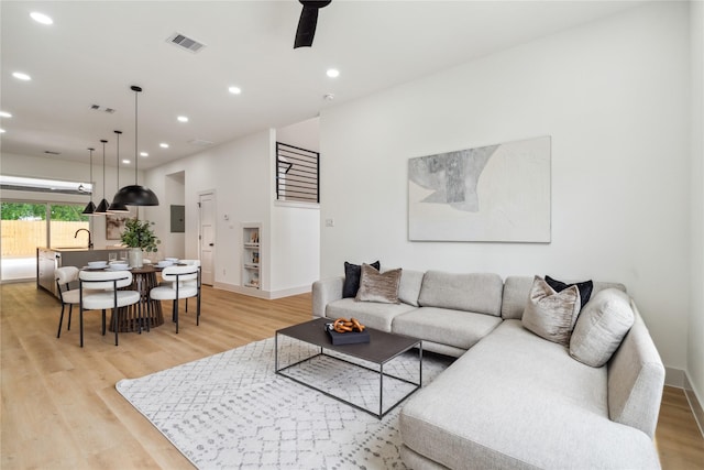 living room featuring recessed lighting, visible vents, and light wood-style floors