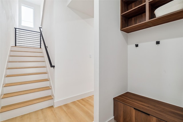 mudroom with light wood finished floors and baseboards