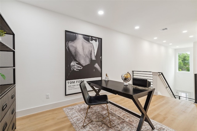 office featuring recessed lighting, light wood-type flooring, visible vents, and baseboards