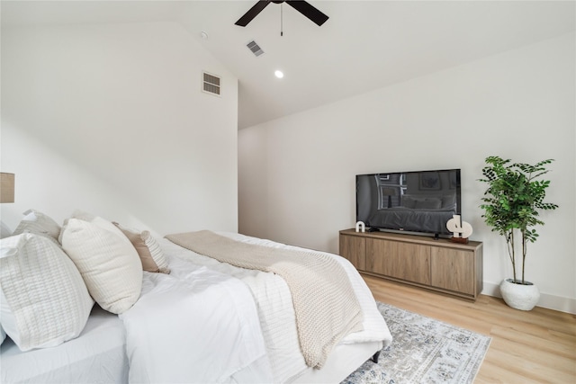 bedroom featuring ceiling fan, lofted ceiling, light wood-style floors, and visible vents