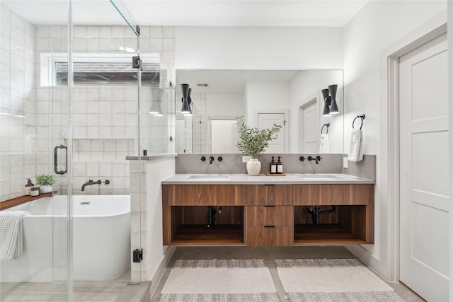 bathroom with a shower stall, a freestanding tub, a sink, and double vanity
