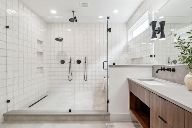 full bath featuring vanity, visible vents, recessed lighting, and a shower stall