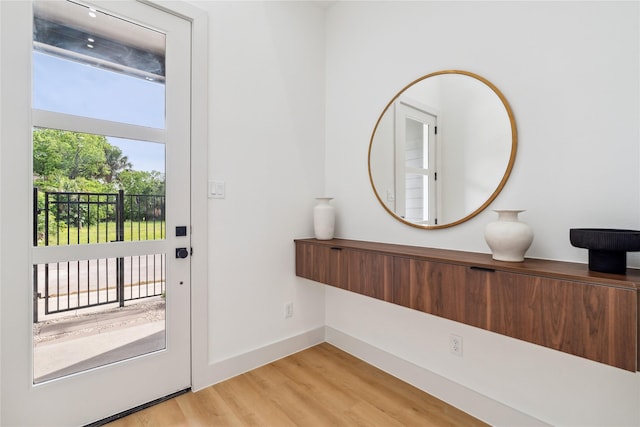 entryway with light wood-type flooring and baseboards