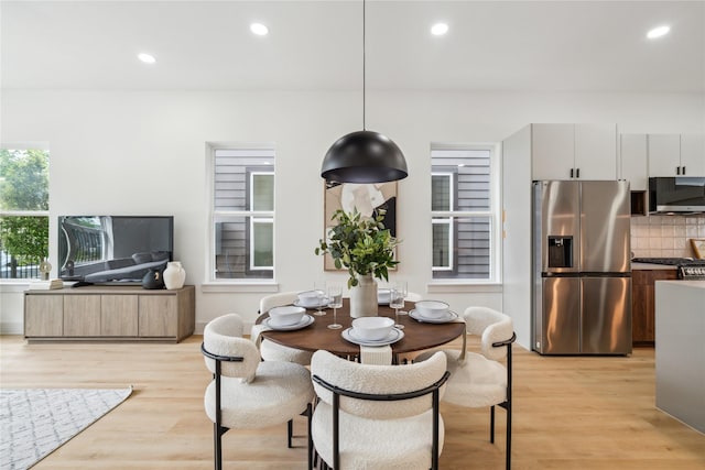 dining room with recessed lighting and light wood-type flooring