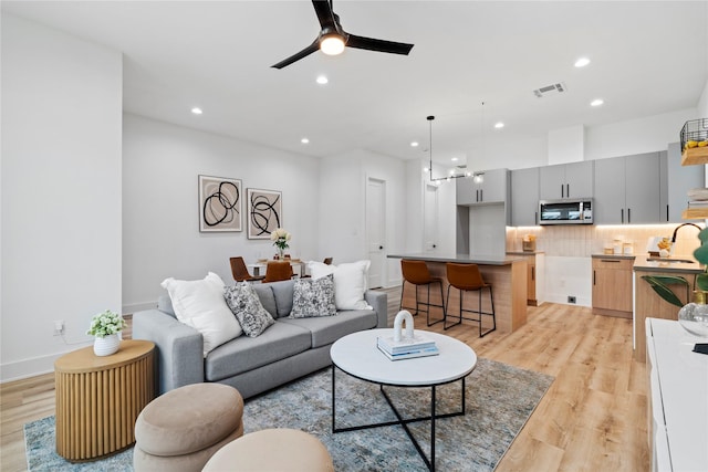 6412 Foster St, Houston, TX 77021 - living room featuring light wood finished floors, recessed lighting, a ceiling fan, visible vents, and baseboards