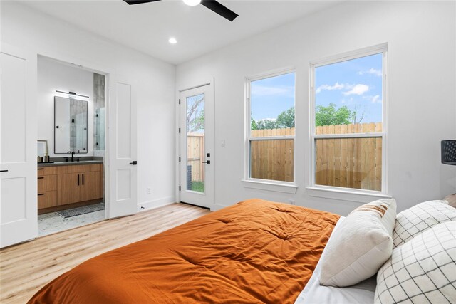 6412 Foster St, Houston, TX 77021 - bedroom featuring recessed lighting, access to exterior, ensuite bathroom, a sink, and light wood-type flooring