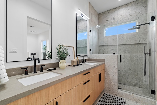 6412 Foster St, Houston, TX 77021 - bathroom featuring a shower stall, visible vents, a sink, and double vanity