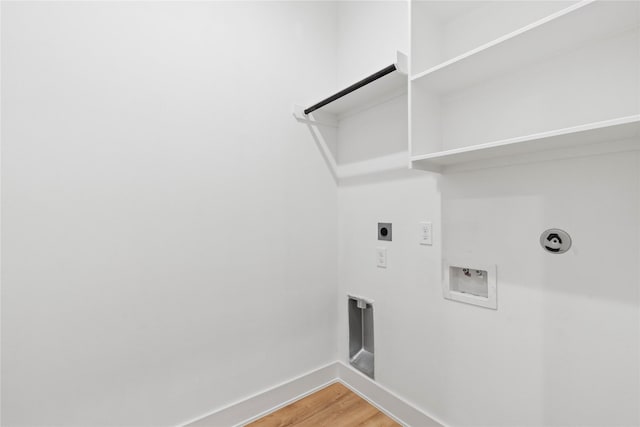 6412 Foster St, Houston, TX 77021 - laundry area featuring laundry area, light wood-style floors, hookup for a washing machine, baseboards, and electric dryer hookup