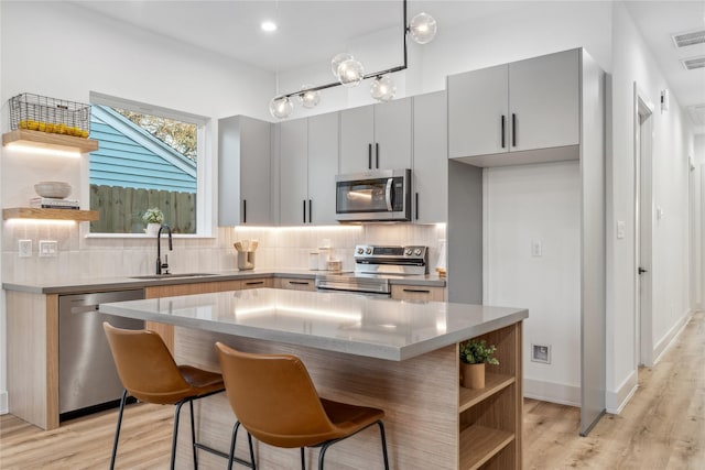 6412 Foster St, Houston, TX 77021 - kitchen with open shelves, appliances with stainless steel finishes, decorative backsplash, and a sink