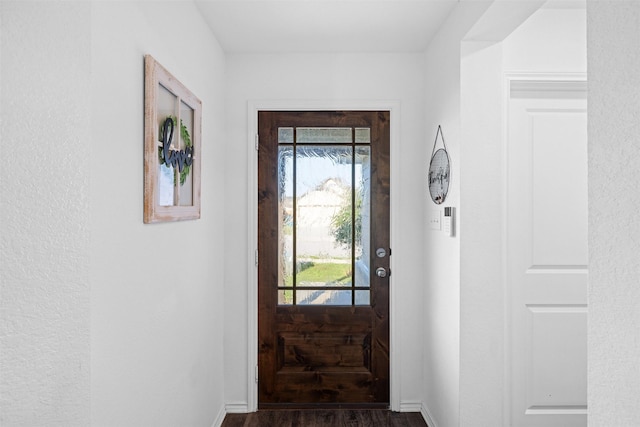 125 Dove Landing Ct, Navasota, TX 77868 - doorway featuring baseboards and dark wood-style flooring