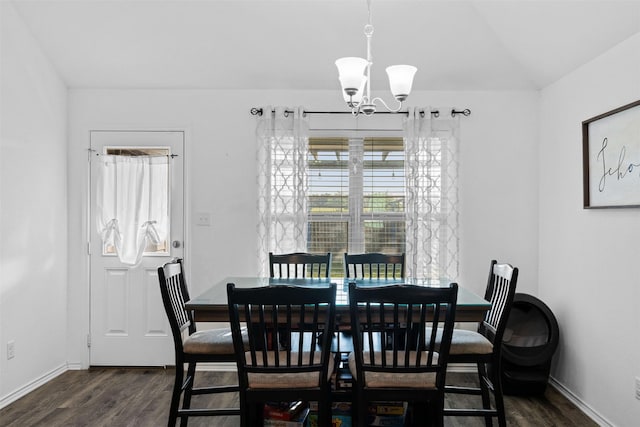 125 Dove Landing Ct, Navasota, TX 77868 - dining room with baseboards, dark wood-style floors, and an inviting chandelier
