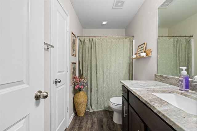 125 Dove Landing Ct, Navasota, TX 77868 - bathroom featuring toilet, vanity, wood finished floors, and visible vents