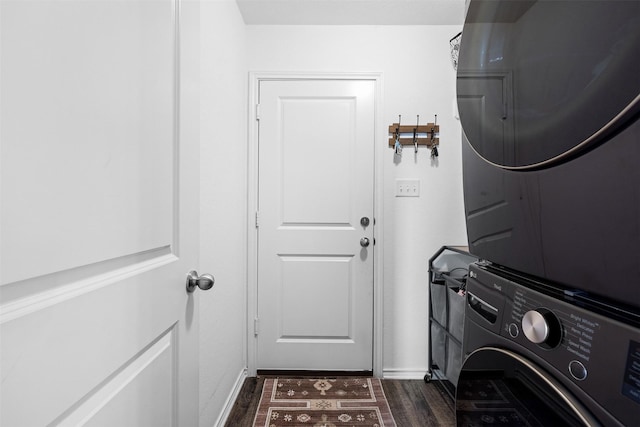 125 Dove Landing Ct, Navasota, TX 77868 - washroom with dark wood-type flooring, stacked washing maching and dryer, baseboards, and laundry area