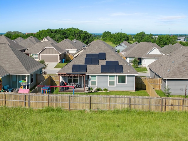 125 Dove Landing Ct, Navasota, TX 77868 - back of house featuring a residential view, roof mounted solar panels, a patio, and a fenced backyard