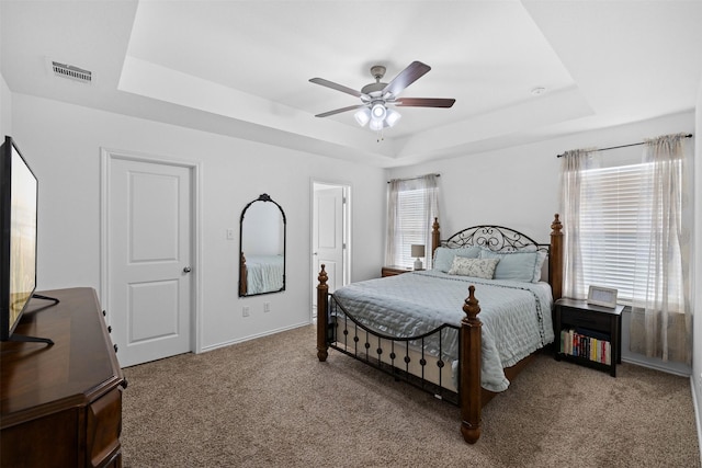 125 Dove Landing Ct, Navasota, TX 77868 - carpeted bedroom featuring baseboards, a ceiling fan, visible vents, and a raised ceiling