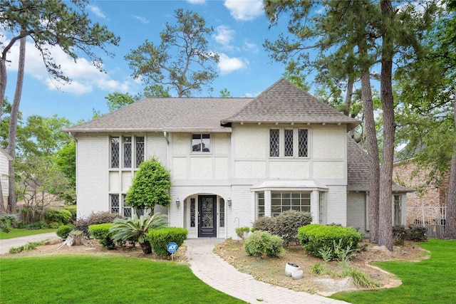 2014 Anvil Dr, Houston, TX 77090 - view of front of house with a front lawn, roof with shingles, brick siding, and stucco siding