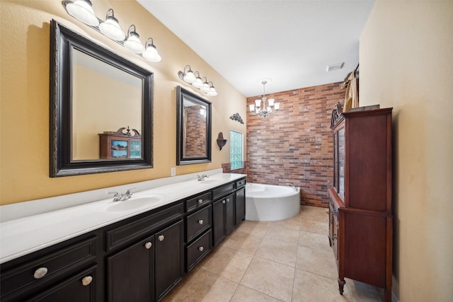 236 Camden Hills Dr, Montgomery, TX 77356 - bathroom featuring a chandelier, double vanity, a soaking tub, tile patterned floors, and brick wall