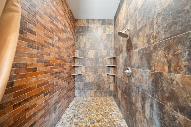 236 Camden Hills Dr, Montgomery, TX 77356 - bathroom featuring tiled shower and a textured ceiling