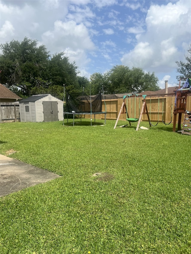 2711 N Belgravia Dr, Pearland, TX 77584 - view of yard with a fenced backyard, a trampoline, a playground, and a storage unit