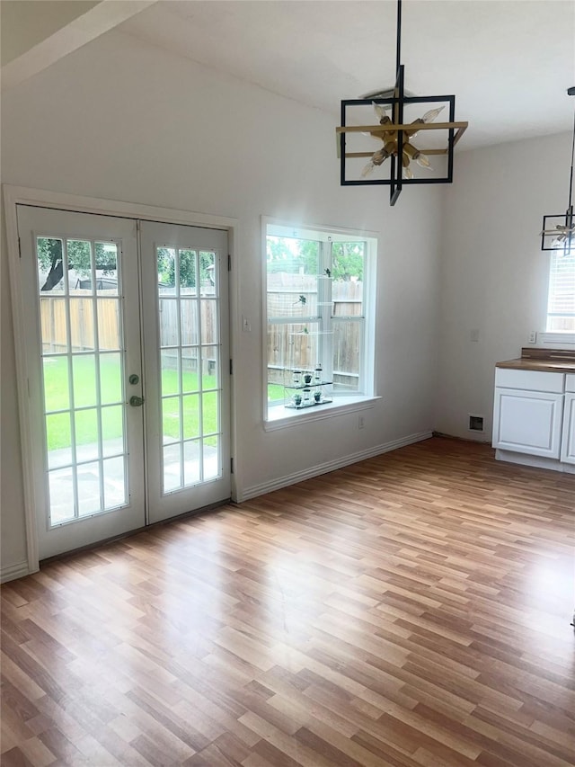 2711 N Belgravia Dr, Pearland, TX 77584 - doorway to outside featuring french doors, baseboards, wood finished floors, and a notable chandelier