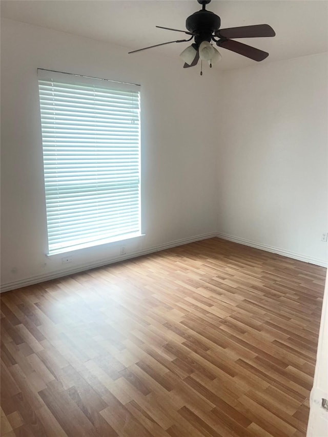 2711 N Belgravia Dr, Pearland, TX 77584 - empty room with a ceiling fan, baseboards, and wood finished floors