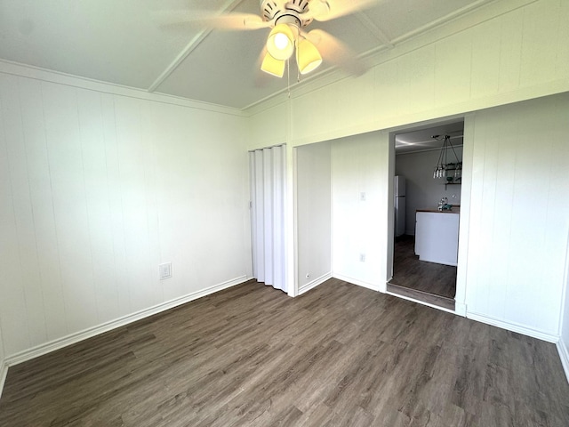 unfurnished bedroom with baseboards, a ceiling fan, and wood finished floors