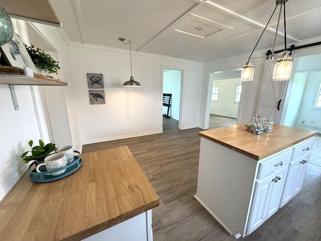 kitchen with white cabinets, dark wood-style floors, butcher block countertops, and pendant lighting