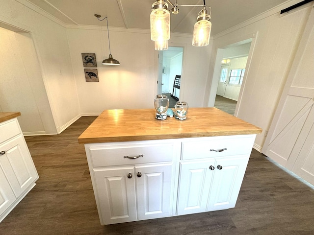 kitchen with dark wood finished floors, butcher block countertops, white cabinetry, and crown molding