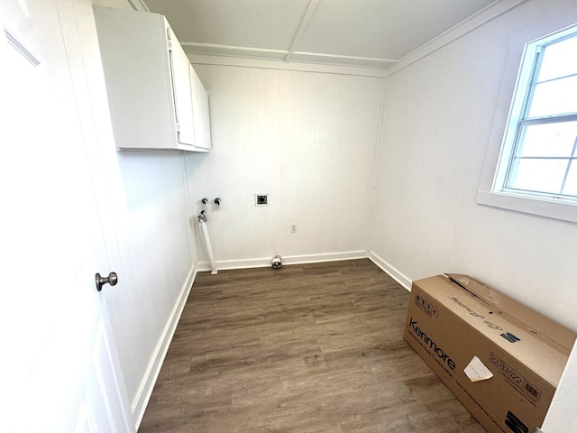washroom featuring baseboards, dark wood finished floors, washer hookup, and cabinet space