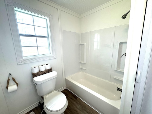 bathroom featuring toilet, wood finished floors, and shower / bathing tub combination