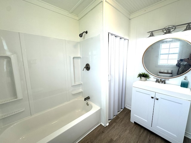 full bath featuring ornamental molding, vanity, wood finished floors, and  shower combination
