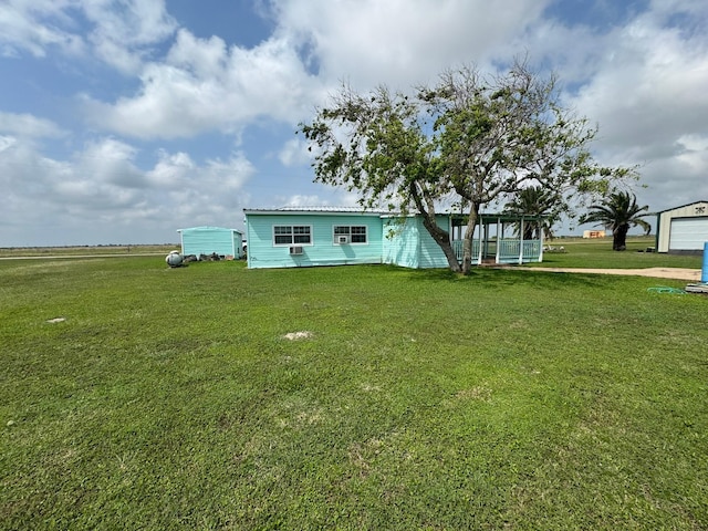 rear view of property with a lawn