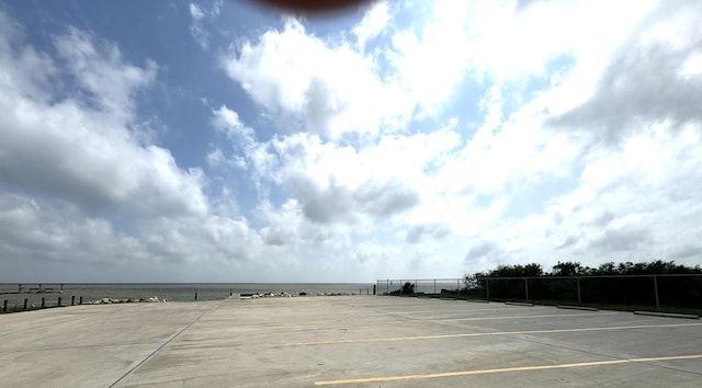 exterior space featuring fence and a tennis court