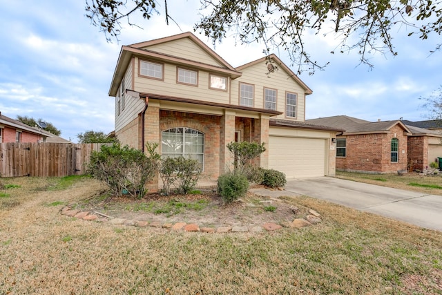 traditional-style home with fence, an attached garage, a front yard, and concrete driveway