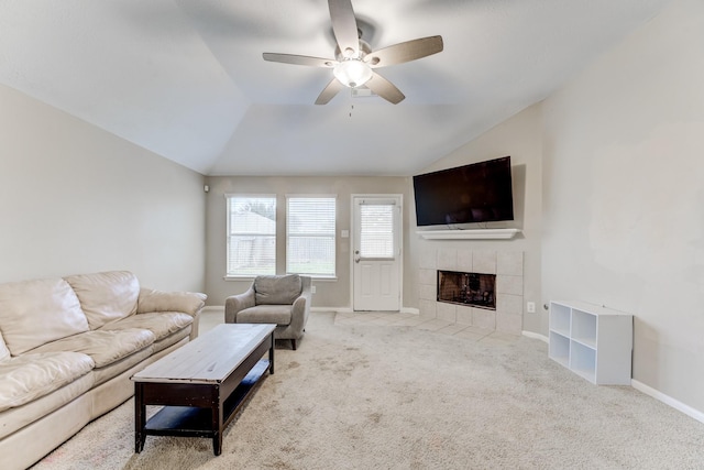 living room featuring lofted ceiling, carpet, a ceiling fan, baseboards, and a fireplace