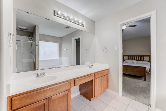 bathroom with tile patterned floors, a sink, double vanity, a tile shower, and visible vents