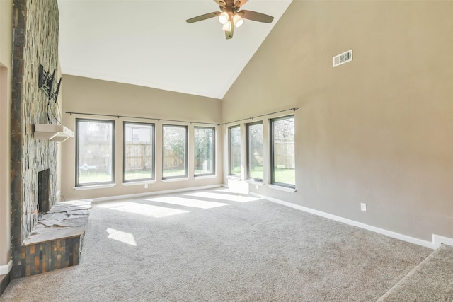unfurnished living room with carpet, visible vents, a ceiling fan, baseboards, and high vaulted ceiling