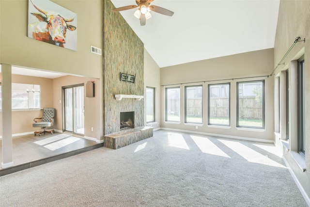 unfurnished living room with high vaulted ceiling, baseboards, carpet flooring, and visible vents