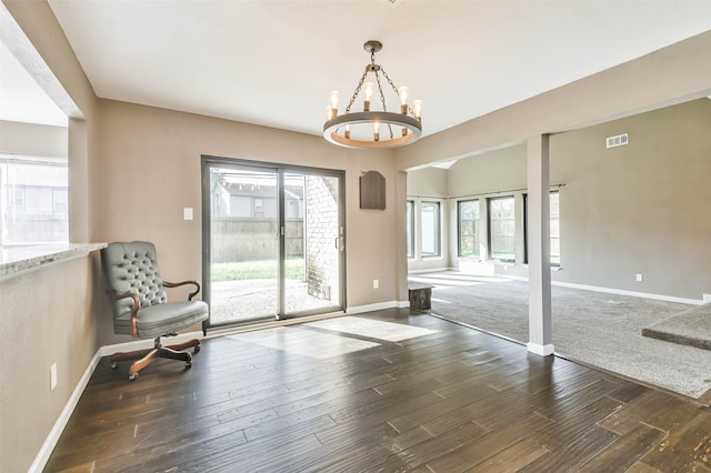 sitting room with visible vents, wood finished floors, baseboards, and an inviting chandelier
