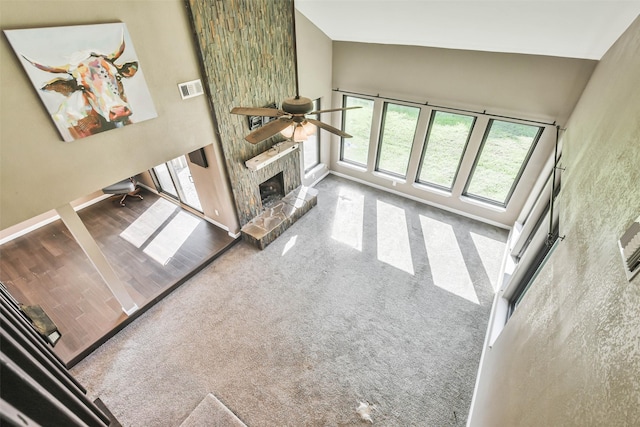 unfurnished living room featuring high vaulted ceiling, visible vents, a ceiling fan, and baseboards