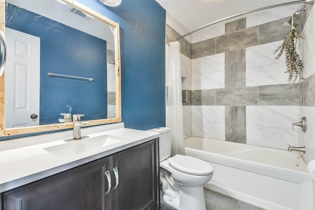full bath with shower / tub combo, toilet, vanity, and visible vents