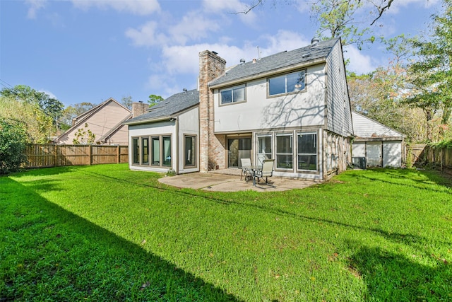 rear view of property with a patio area, a lawn, and a fenced backyard