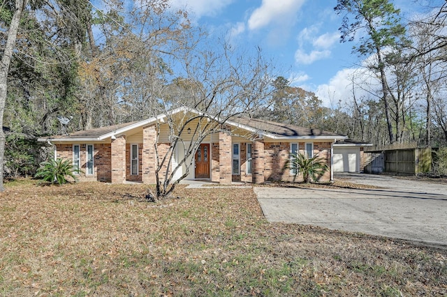 ranch-style house with brick siding, an attached garage, fence, and driveway
