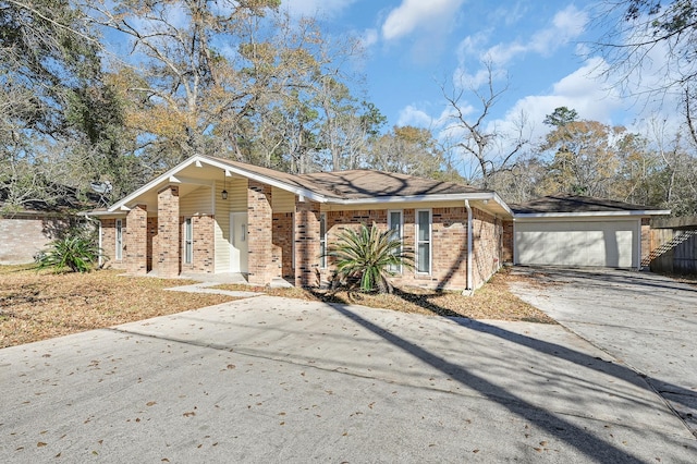 view of front facade with brick siding, a garage, concrete driveway, and fence