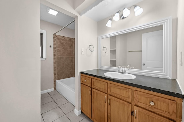 bathroom featuring baseboards, bathtub / shower combination, vanity, and tile patterned floors